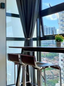 a table and two chairs in front of a window at Private Jacuzzi Staycation at KL City 152 in Kuala Lumpur