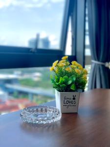 a small flower pot sitting on a table with a plant at Private Jacuzzi Staycation at KL City 152 in Kuala Lumpur