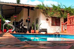 a swimming pool in front of a house at Hermosa Finca "Rancho 4Js" in La Cumbre