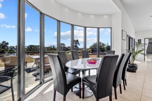 a dining room with a table and chairs at Blu-Sea 365 in Bicheno