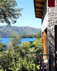 a view of a lake from a balcony of a building at La casa providencia - Costa del lago in Villa Pehuenia