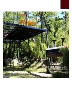 a yellow machine on a lift in the woods at La casa providencia - Costa del lago in Villa Pehuenia +14 photos