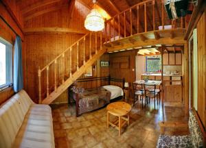 a living room with a staircase in a wooden house at 9 Musses Hotel Apartments in Skala Mistegnon