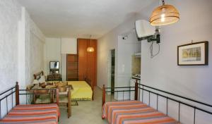 a living room with a bed and a table at 9 Musses Hotel Apartments in Skala Mistegnon