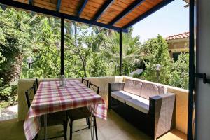 a patio with a table and a chair and a table and a table andearcher at 9 Musses Hotel Apartments in Skala Mistegnon