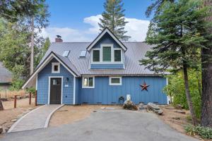 a house with a blue garage at Starfall in Yosemite West