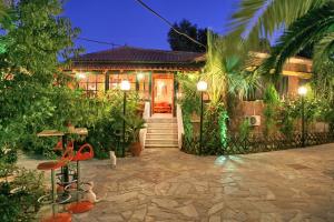 a house with a pathway leading to the front door at 9 Musses Hotel Apartments in Skala Mistegnon