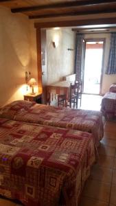 a bedroom with a bed and a dining room with a table at Hôtel Les Bernards in Praz-sur-Arly +29 photos