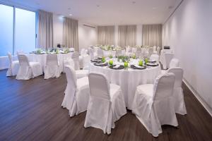 a room with white tables and chairs with white tablecloths at Senhora da Rosa, Tradition & Nature Hotel in Ponta Delgada +37 photos