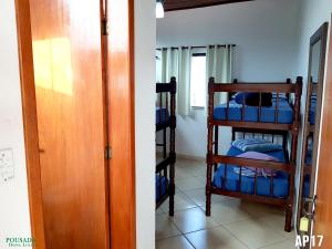 a room with two bunk beds and a door at Pousada Dona Lolita in Cachoeira Paulista