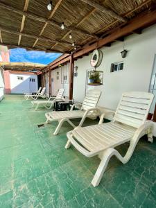 a group of lounge chairs sitting on a patio at La Nueva Romana in Santa Clara del Mar