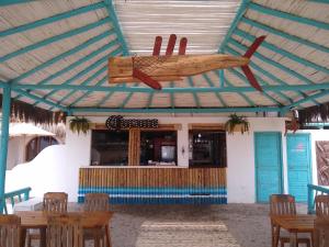 a wooden airplane hanging from the ceiling of a restaurant at Hamacas in Punta Negra