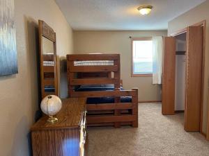 a bedroom with two bunk beds and a table with a lamp at Close to Duluth! Centrally Located-Lake Superior Minutes Away! in Superior