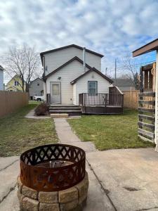 a white house with a fence and a yard at Close to Duluth! Centrally Located-Lake Superior Minutes Away! in Superior