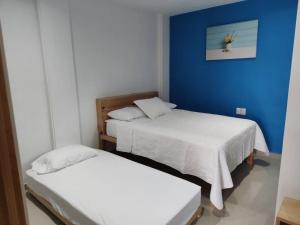 Habitación con 2 camas y pared azul en Azul departamento 34 m2 Nuevo, en Jiutepec