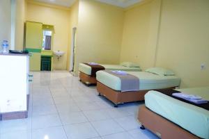 Ένα ή περισσότερα κρεβάτια σε δωμάτιο στο Plum Hotel Lading Banda Aceh