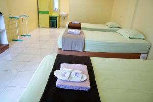 Ένα ή περισσότερα κρεβάτια σε δωμάτιο στο Plum Hotel Lading Banda Aceh