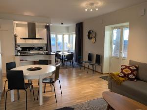 a living room with a table and chairs and a kitchen at Stava Mosters in Mariehamn