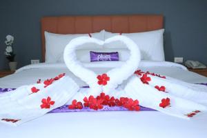 Ένα ή περισσότερα κρεβάτια σε δωμάτιο στο Plum Hotel Lading Banda Aceh