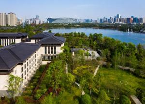 een luchtzicht op een gebouw met een rivier en een stad bij Gran Melia Chengdu in Chengdu