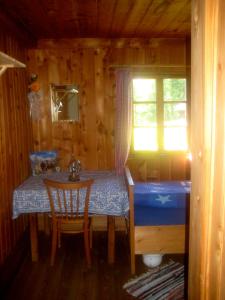 a bedroom with a table and a bed in a cabin at Almhütte Gorgasser in Heiligenblut