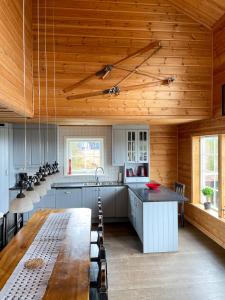 a kitchen with a long table and a wooden ceiling at Ski Lodge Idre Fjäll in Idre