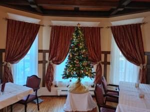 a christmas tree in a living room with a table at Marmora and Lake Inn and Victorian Diner in Marmora
