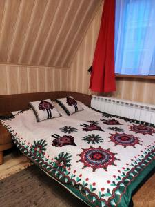 a bed with two pillows on it in a room at Marynka in Zakopane