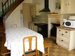 a kitchen with a table with a microwave on it at Gîte Chabris, 5 pièces, 11 personnes - FR-1-591-18 in Chabris