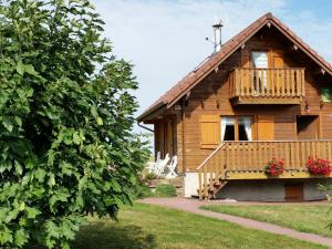 a wooden house with a porch and a balcony at Charmant Chalet Vosgien – Idéal Couple/Curistes – Calme et Nature – Proche Plombières-les-Bains - FR-1-589-230 in Le Val-dʼAjol