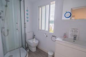 a bathroom with a toilet and a shower and a sink at E368 Casa Blanca by Mallorca Villa Selection in Alcudia +26 photos