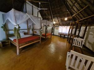 an overhead view of a bedroom with a canopy bed at Honey Badger Lodge in Moshi