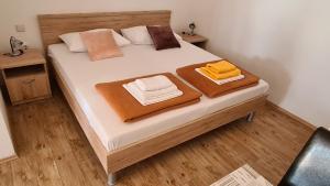 a bedroom with a bed with towels on it at Apartments Kust in Mlini