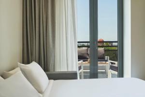 A bed or beds in a room at NLH KERAMEIKOS - Neighborhood Lifestyle Hotels
