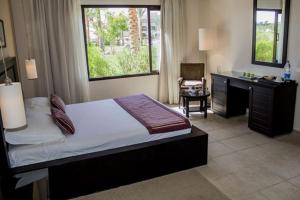 A bed or beds in a room at JAZ Neo Saraya Palms