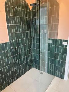 a bathroom with a shower stall and a walk in shower at Port O' Call Motel in Port Campbell