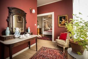 a room with red walls and a table with a mirror at Carcassonne Bed and Breakfast du Palais in Carcassonne