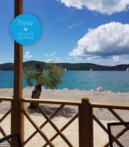 a view of the beach from the porch of a house at Deluxe Beach Mobile Homes in Šibenik