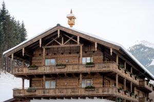 a log cabin with a clock tower on top of it at Wieshofgut in Saalbach Hinterglemm