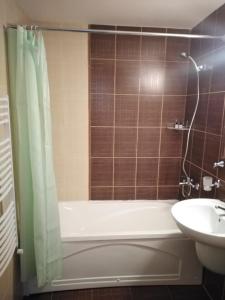 a bathroom with a bath tub and a sink at Bansko Royal Towers - Studio 536 in Bansko +18 photos