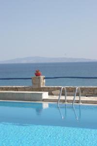 a swimming pool with the ocean in the background at Silver Rocks Hotel in Chrissi Akti