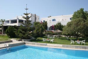 a resort with a swimming pool in front of a building at Silver Rocks Hotel in Chrissi Akti