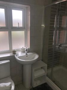 y baño con lavabo, ducha y aseo. en 2 Bedroom Large First Floor Apartment with FREE Parking, en Loughborough