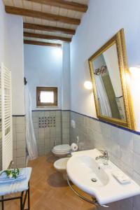 a bathroom with a sink and a toilet and a mirror at Il Borgo Di San Michele in Papigno
