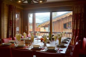 a table in a room with a large window at Chalet Versoye, Montchavin Sunday changeover in Montchavin