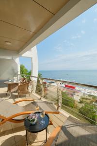 a balcony with a view of the ocean at "Serenity Premium apartments" с панорамным видом на море in Sochi