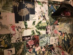 a wall with pictures of plants and flowers on it at Kelston Guest House in Weymouth