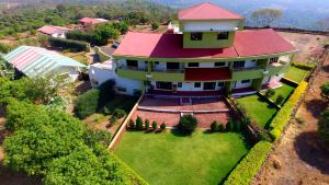 an overhead view of a house with a red roof at Kokanwadi Resort in Ratnagiri
