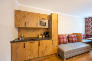 a kitchen with a sink and a microwave at Ferienhotel Gasthof zur Post in Untertauern