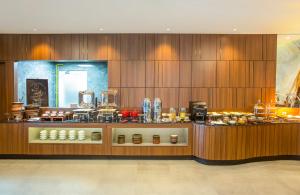 a restaurant with a counter with food on it at Swiss-Belhotel Cendrawasih, Biak in Fandoi